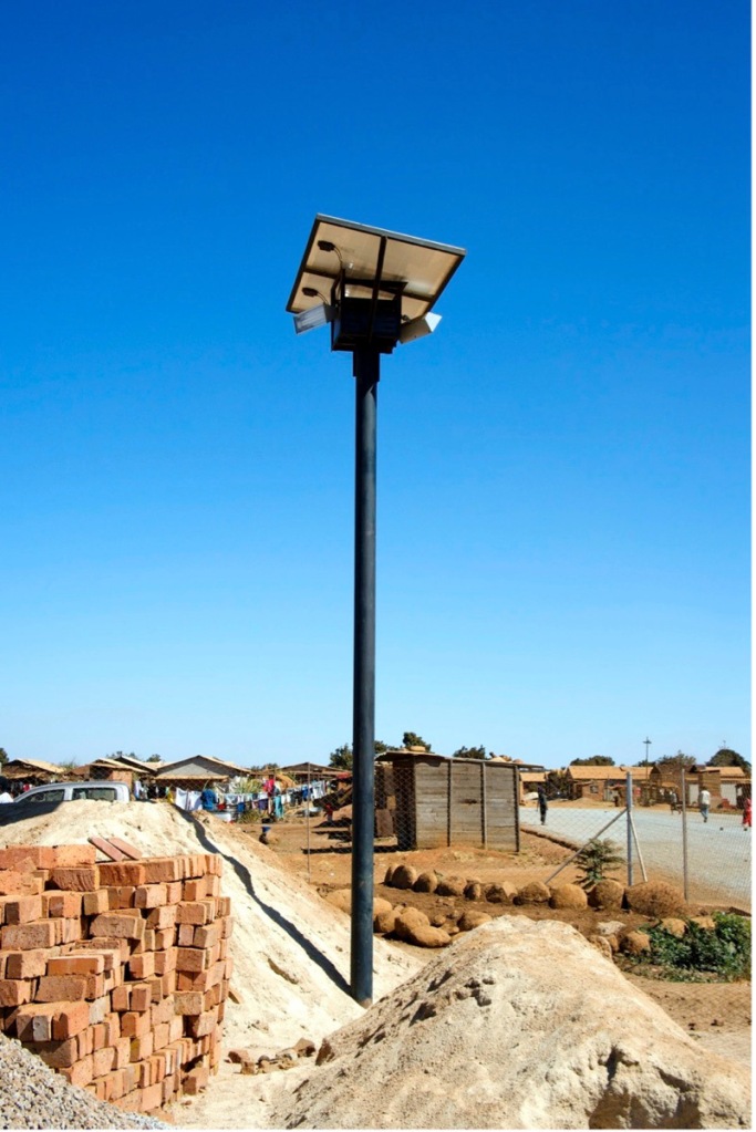 Solar-powered streetlights have been installed recently — here under construction — increasing public safety and providing light to the community.